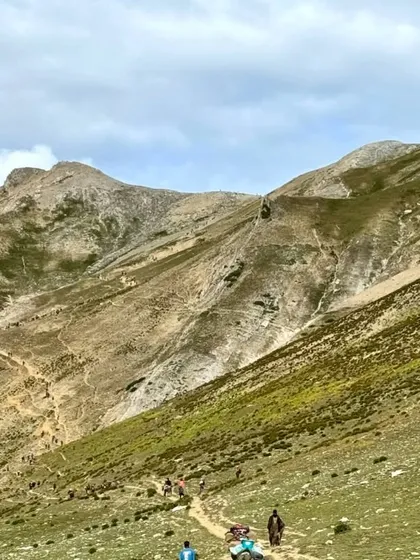 Our group of trekkers making their way along a high mountain trail. The sense of shared adventure and determination is a core part of the experience.