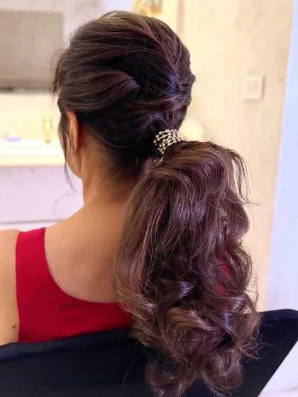 Another angle of the textured low ponytail, showing the intricate twists at the base.