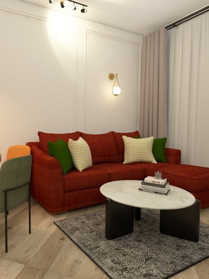 Another view of the living room, showing the L-shaped red sofa and the oval marble-top coffee table.