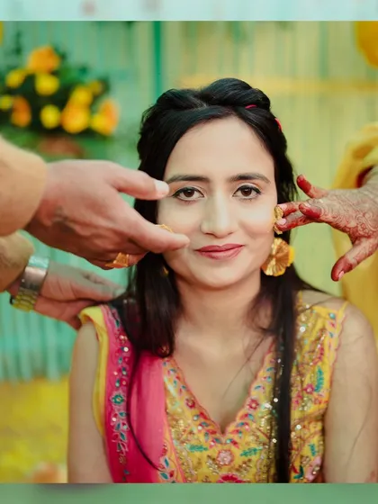 The Haldi ceremony is all about vibrant colors and playful moments. Here, we capture the bride being lovingly adorned with turmeric by her family, a key tradition filled with smiles and blessings.
