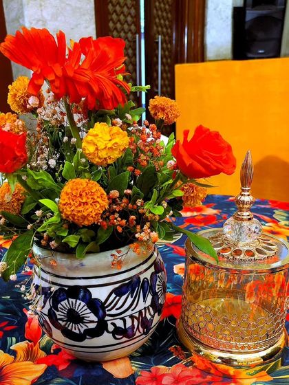 A detail of the table decor for the Turkish-themed Haldi. I used hand-painted ceramic vases filled with marigolds and a beautiful glass jar with intricate gold detailing to bring the theme to life.