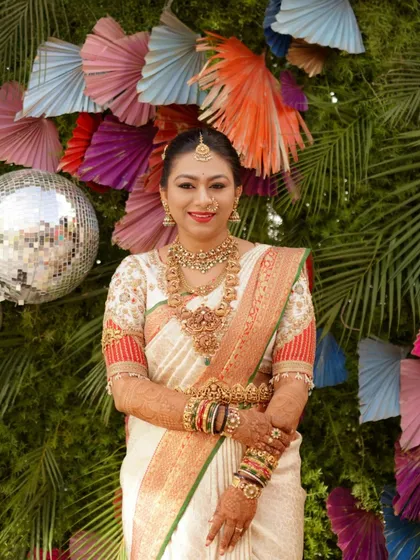 A full view of the bride's wedding attire. The custom-designed blouse and classic saree create a timeless and elegant silhouette for her special day.