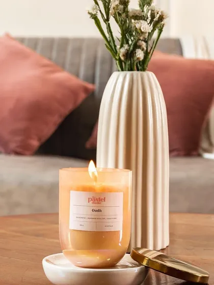 Another lifestyle shot of The Pastel Studio's candle, placed in a living room setting to help customers visualize the product in their own homes.