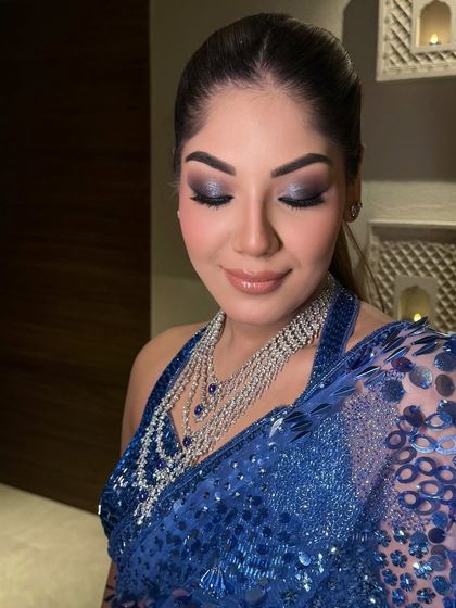 A close-up of the bride's makeup, her hair pulled back into a sleek and powerful high ponytail.