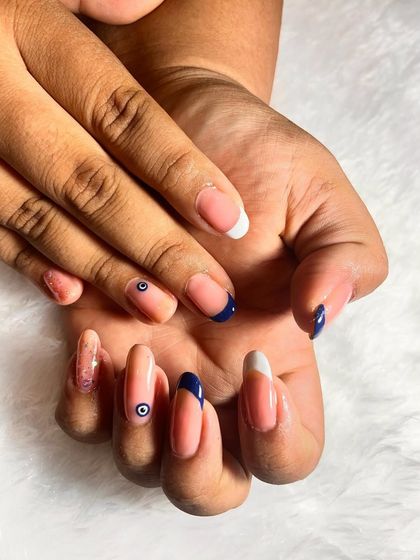 Another view of the evil eye nail art set. The combination of the classic French manicure with the trendy evil eye symbol is very stylish.