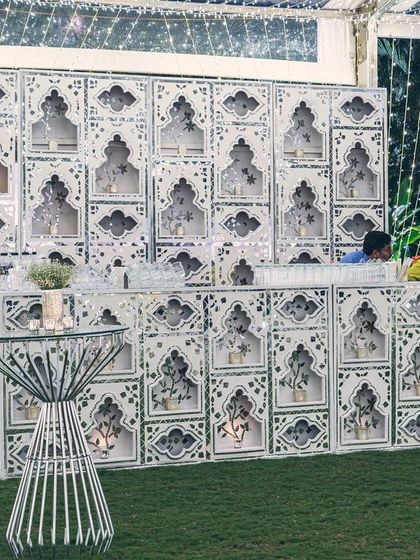 The impressive Thikri-paneled bar, a statement piece at the sangeet. The geometric patterns and mirrored surfaces make it a central hub of activity and style.