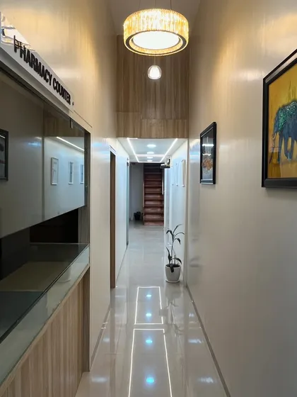 The clinic's hallway is designed to be bright and clean, leading you from the reception and pharmacy counter to the private consultation and treatment areas.