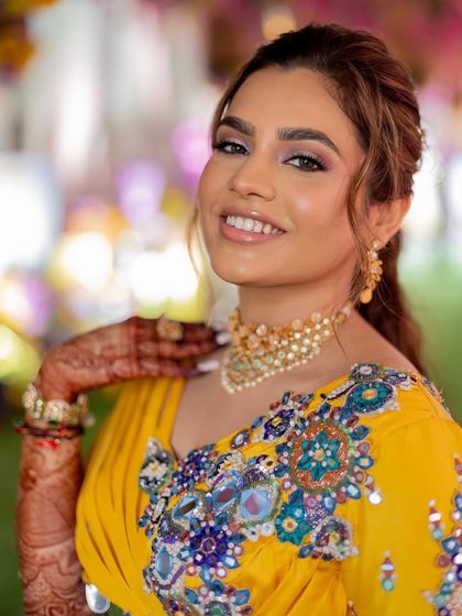 A close-up of the haldi makeup, featuring a soft purple-toned eyeshadow to pick up the colors in the outfit.