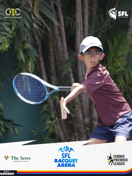A young competitor with glasses shows great technique on his backhand, tracking the ball all the way to his racquet.