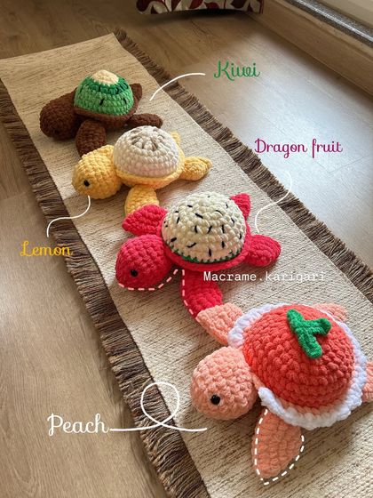 Our fruit turtle collection lined up! You can see the different designs we offer: Kiwi, Lemon, Dragon fruit, and Peach. Each one is made with soft chunky yarn.