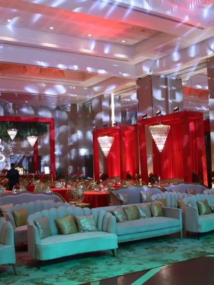 We transformed this ballroom into a luxurious red and gold haven. With plush lounge sofas, grand chandeliers, and dramatic red draping, the entire space radiated a sense of grandeur and festivity for this special celebration.