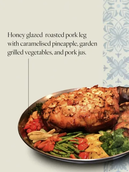 My honey-glazed roasted pork leg, served with caramelized pineapple and garden vegetables. It's slow-roasted for hours to achieve a perfect balance of sweet and savory.