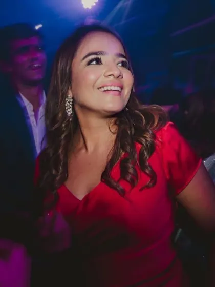A candid shot of Anisha enjoying the party. My goal is to create makeup that not only looks good in photos but also lets you live in the moment.