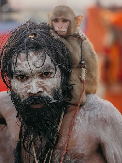 A striking portrait of a sadhu with his monkey companion at the Kumbh Mela. The ash on his face and the monkey's innocent expression create a powerful contrast.