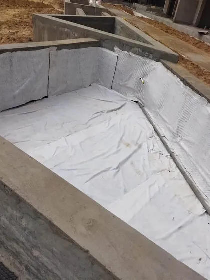 A corner detail of the waterproofing and drainage system installation. We pay close attention to every detail to ensure the longevity of our landscapes.