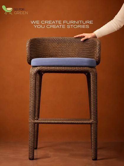 We create the furniture, you create the stories. This image features our classic wicker bar stool with a custom blue cushion, a piece designed to be a part of your home's memorable moments.