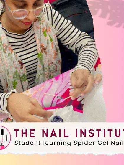 We stay on top of the latest trends. Here, a student is practicing with spider gel, a popular material for creating sharp, intricate line art and web designs.
