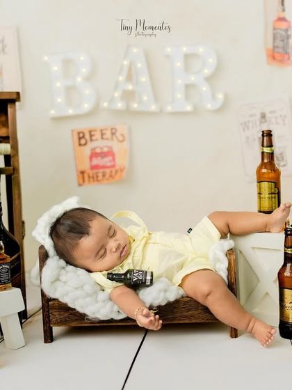 It's been a long day at the bar. This humorous and unique setup is perfect for parents looking for a funny and memorable baby photo.