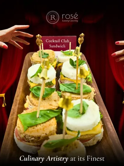 Culinary artistry at its finest. These creative cocktail club sandwiches are carefully assembled and presented on a wooden board, showcasing our flair for turning simple concepts into gourmet delights.