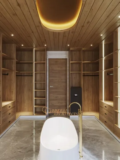 This unique bathroom design combines a freestanding bathtub with a spacious walk-in closet, all set under a warm, wood-paneled ceiling with a statement cove light.