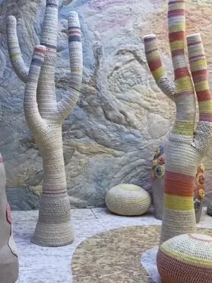 The crocheted cactus landscape of 'Hope You're Well'. The soft, hand-worked forms stand in a surreal desert, creating a space that feels both gentle and resilient.