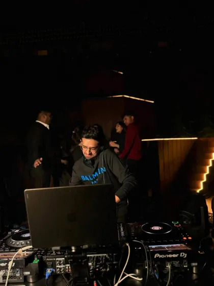 Behind the laptop at another club event. It's a constant grind, but I love every minute of it.