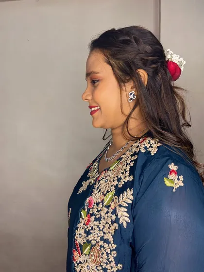 A side profile showing the soft curls and braided detail in her hair.