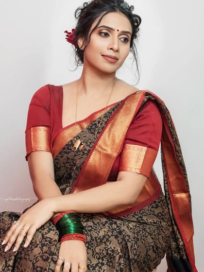 A series of studio portraits featuring a model in a black and red printed saree. The images range from expressive close-ups to elegant full-body shots, demonstrating versatile studio lighting.