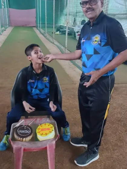 A coach sharing a piece of birthday cake with Tanish. These moments build a strong bond.