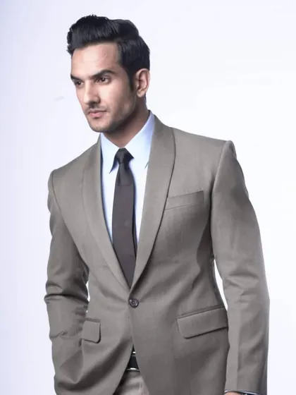 An example of a bespoke blazer with a distinctive shawl lapel, crafted in a versatile light grey fabric. This is a great option when you want a formal look that stands apart from a standard business suit.