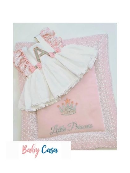 A beautiful personalized set for a little princess, featuring a dress with her initial 'A' and a matching quilted wrap. This is a perfect gift for a baby announcement.