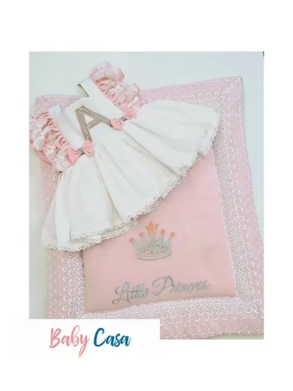 A beautiful personalized set for a little princess, featuring a dress with her initial 'A' and a matching quilted wrap. This is a perfect gift for a baby announcement.