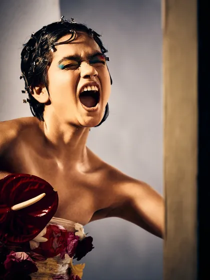 Makeup can be a raw, unfiltered expression of emotion. For this conceptual piece, I used a burst of color and texture, from the bold, imperfect eye makeup to the floral adornments, to capture a moment of pure, rebellious energy.