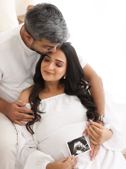 The first family heirloom. Holding the sonogram picture together, with his gentle kiss on her forehead, makes this an incredibly personal and heartwarming portrait.