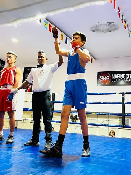 A young boxer's hand is raised in victory during the DSO tournament at our academy. This is the moment all the hard work pays for.