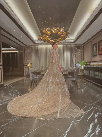 A wide shot showing the magnificent trail of the lehenga. This look was designed to make a grand statement from every angle.