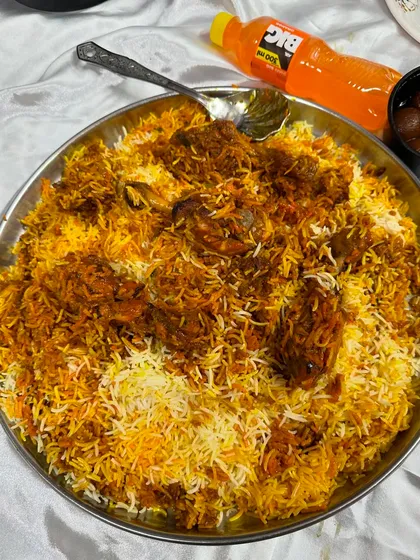 Look at the color and texture of our Chicken Drumstick Biryani. Each grain of rice is separate and the masala is perfectly cooked. This is what authentic biryani looks like.