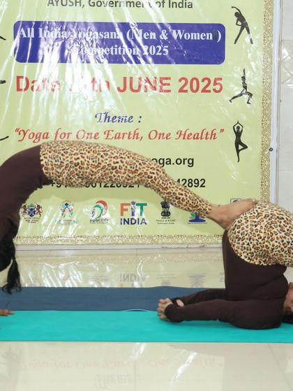 A partner backbend that requires both strength from the base partner and flexibility from the flyer. This pose is a stunning display of trust and physical prowess.