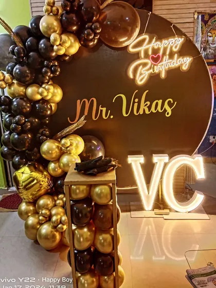 A close-up of the black and gold 'Mr. Vikas' birthday setup. I can add custom names and initials to any decoration to make it more personal.