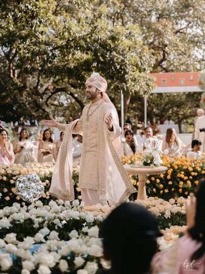 The groom takes center stage in a sea of roses. We designed the ceremony layout to feel immersive, placing the couple right in the heart of the floral landscape.