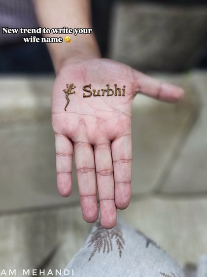 A fun and simple way to include your wife's name in your mehndi. This design features the name 'Surbhi' alongside a small, quirky lizard motif for a touch of personality.