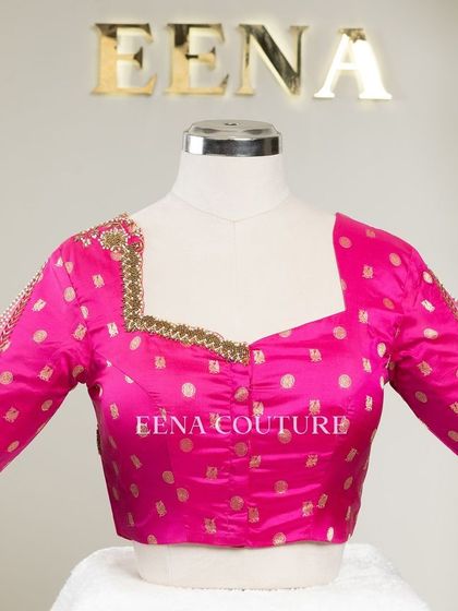 A closer look at the craftsmanship of this pink pure silk blouse. It features intricate handwork with bead detailing on the neckline and delicate net sleeves with linear embroidery for a touch of grace.