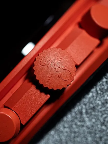 The co-branded "S x O" logo etched into the crown of the "Lava" Moonswatch. It's these small details that make the collection special for enthusiasts.