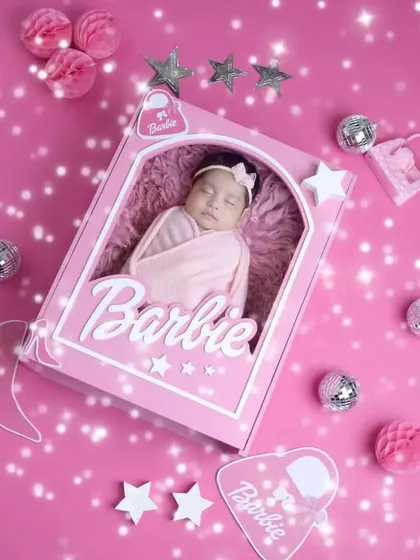 A sparkling and glamorous Barbie-themed newborn portrait. We love bringing creative and playful ideas like this to life for our clients.