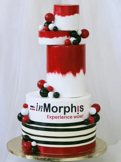 I create impressive cakes for corporate milestones, like this modern, multi-tiered creation. Designed with the company's branding in mind, it uses bold colors and clean lines to make a strong statement at any corporate event or anniversary.