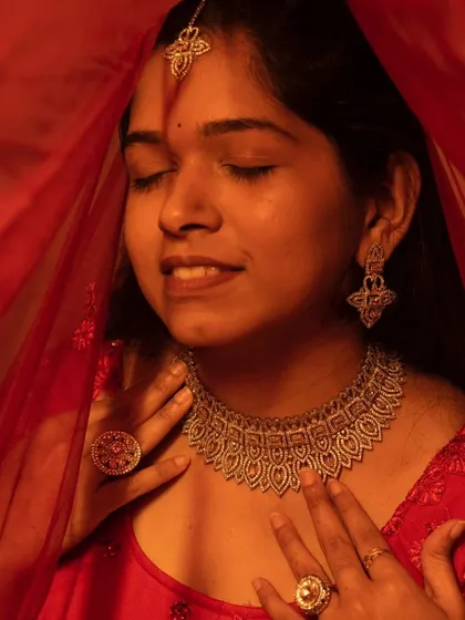 An artistic shot of our client enjoying her moment in our AD jewellery. The sparkle of the choker is visible even in the warm, diffused light.