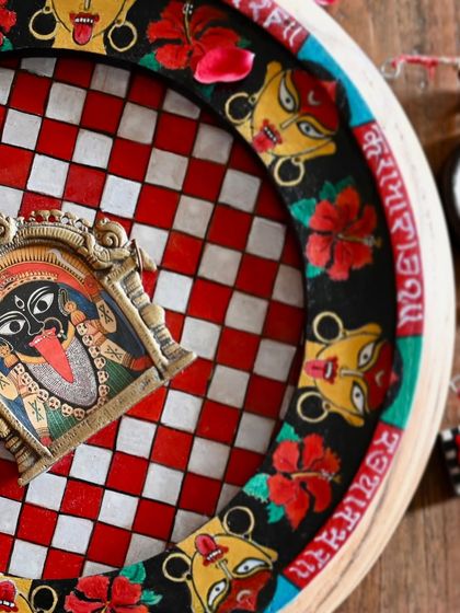 A detail shot of the Kaali frame, focusing on the hand-painted Sanskrit mantra and the powerful imagery of the goddess. The red and black color scheme evokes her fierce, divine feminine energy.