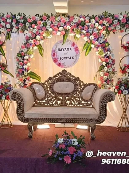 An elegant engagement stage featuring a delicate floral arch in pastel pinks and whites. We included a personalized sign with the couple's names, hanging floral hoops, and coordinated flower stands to complete this romantic look.