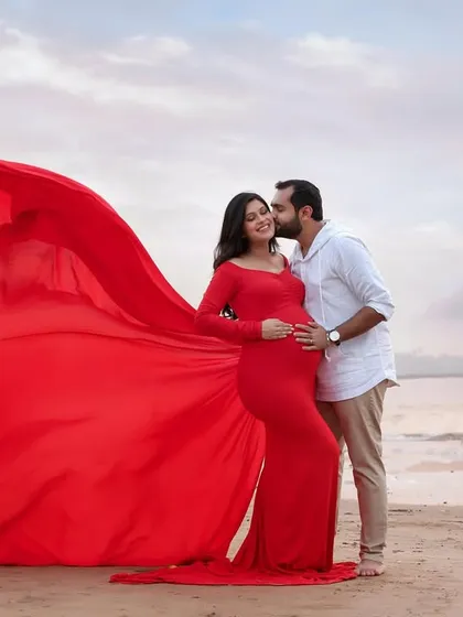 For the mama who wants to feel bold and powerful, we can create something truly epic. This dramatic red gown against the evening sky at the beach makes for an unforgettable, high-energy portrait that celebrates your strength.