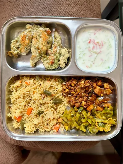 A delicious meal of vegetable biryani, malai chicken, and raita. This shows that you can enjoy flavorful dishes while still maintaining a healthy diet.